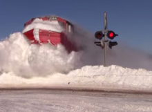 This train  spectacularly plows through tons of snow in New Brunswick